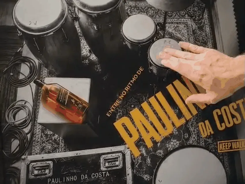 Hand playing the percussion instruments printed on the poster